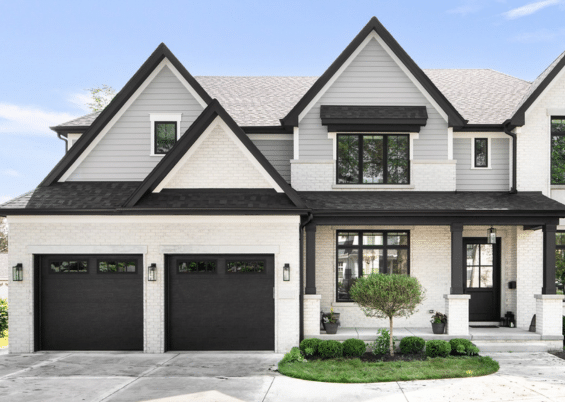 black garage doors on white house