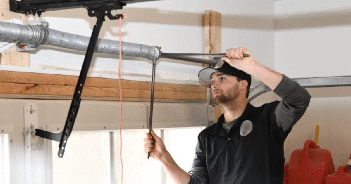 man changing garage door torsion spring