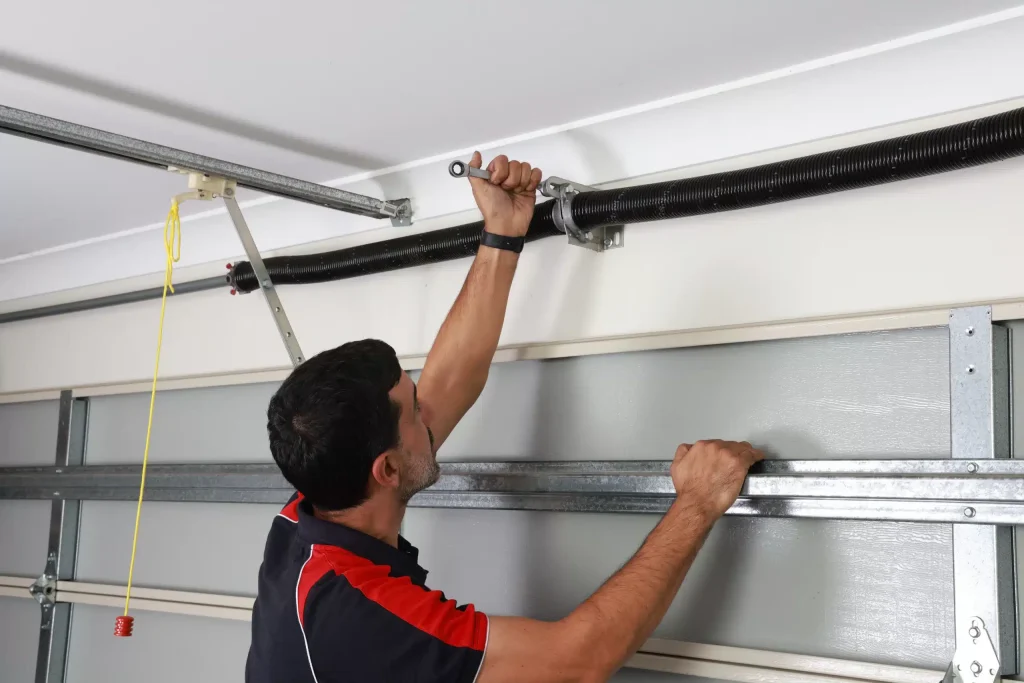 expert repairing garage door spring